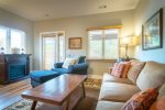 Liiving area with electric fireplace and access to back porch